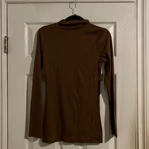 Turtle neck, light brown color. Light fabric, not too thick.